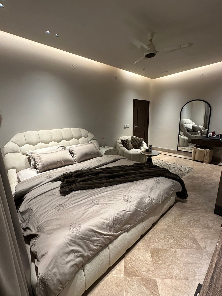Contemporary bedroom with scalloped headboard
